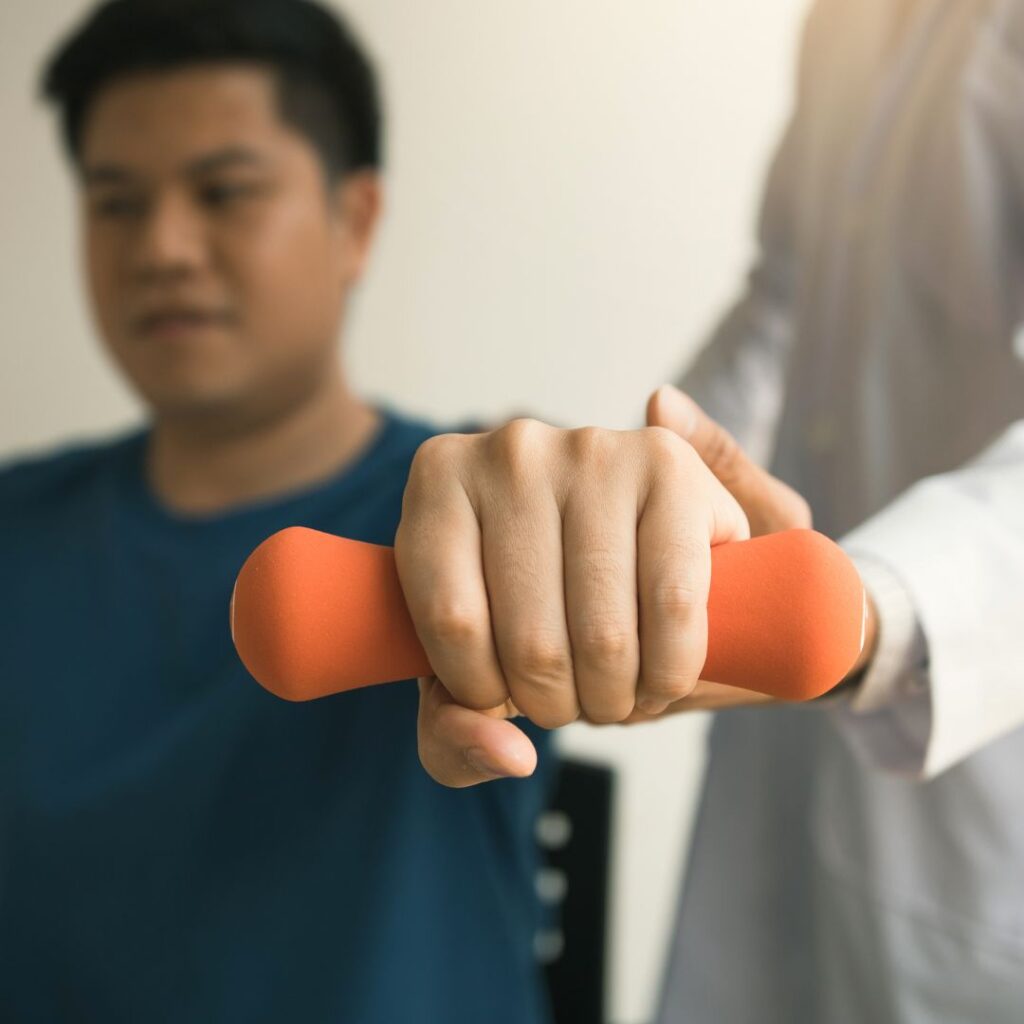 doctor guiding patient lifting weights